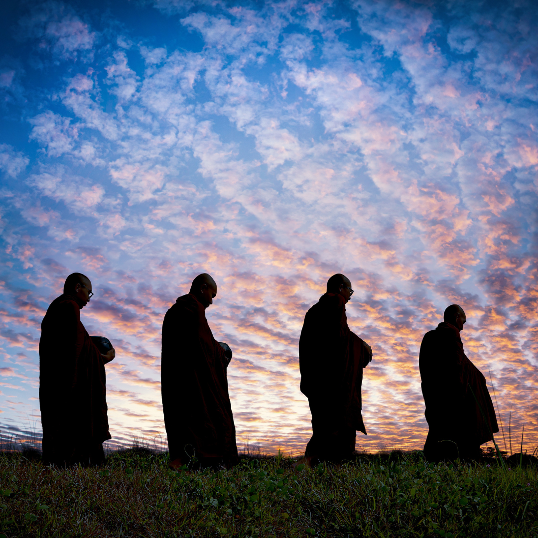 Four Monks walking at sunset